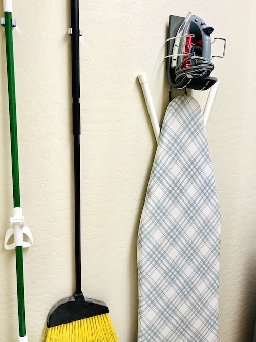 Organize a tiny laundry room: wall mounts for ironing board and cleaning tools