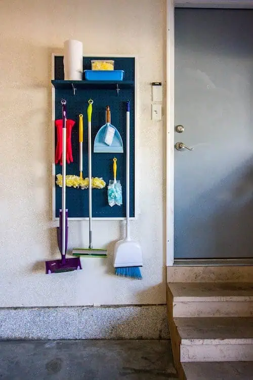 Organize with pegboards: brooms, mops and cleaning supplies