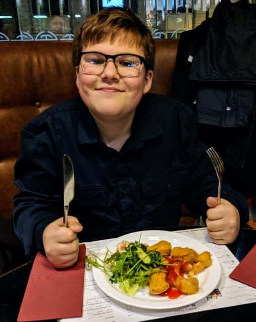 Ben with plate of food smiling