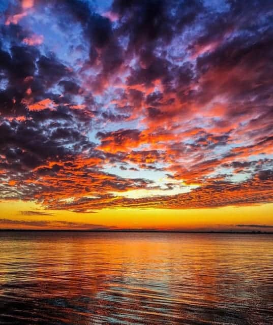 Beautiful sunset with many colors including blue, orange, yellow, purple, pink. Sunset cruise Charleston, SC