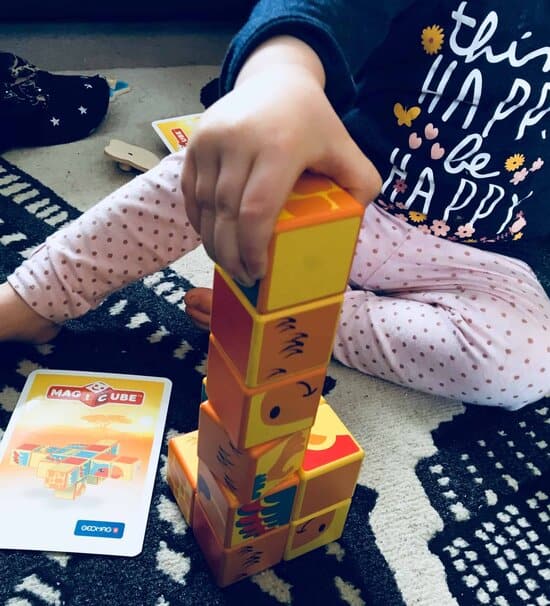 baby girl playing with safari animals magicube