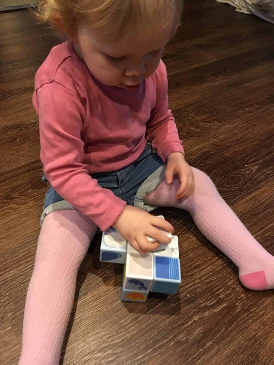 baby girl playing with the magicube polar animals