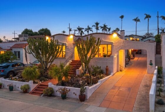 Illuminated stucco home and driveway at dusk at 3559 Villa Terrace in North Park.