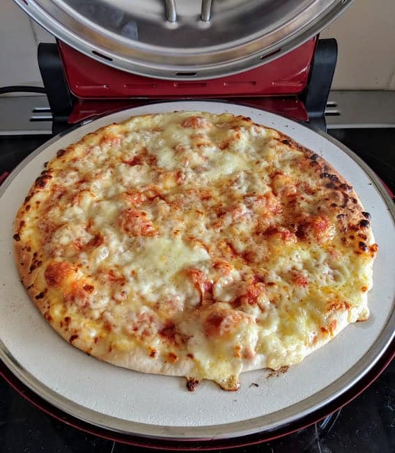A pizza sitting on a white plate