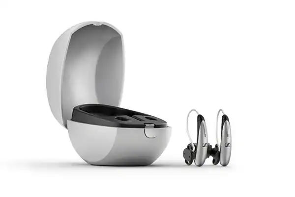 Advanced digital hearing aids with rechargeable batteries and wireless connectivity in a sleek charging case, designed for improved hearing clarity and comfort.