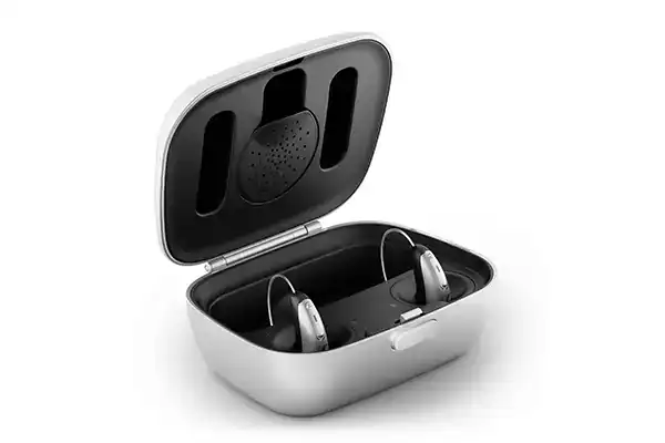 Wireless hearing aids in a charging case, promoting convenient hearing aid management and rechargeable technology for better sound clarity.