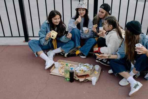 group of people sitting on the concrete floor