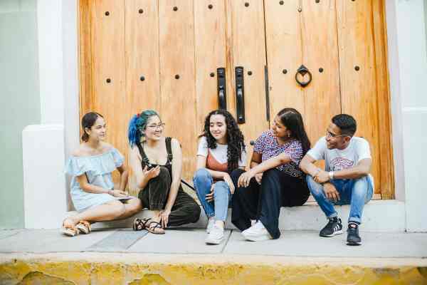 friends sitting by wooden door