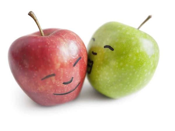 Granny smith apple kissing red apple over white background