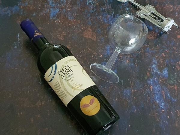 bottle of wine with corkscrew and glass