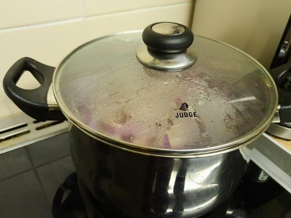 pan steamed up with red onions cooking inside