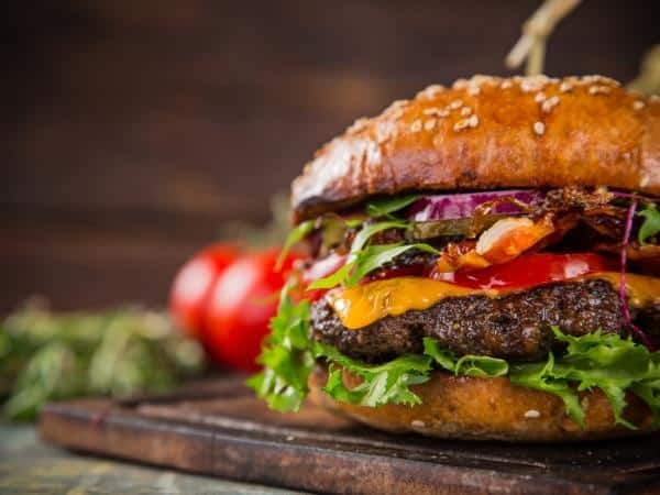 Close up of beef burger with cheese and salad