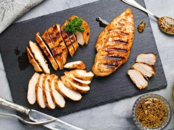 grilled chicken sliced on a slate