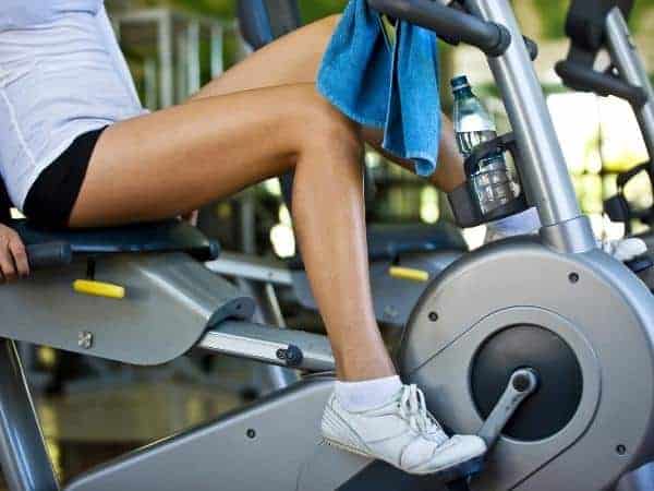 exercise bike with toned legs riding it.