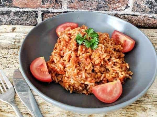 Nigerian jollof rice is a great east meal and served with fresh tomatoes like this perfectly fits the Slimming World guide