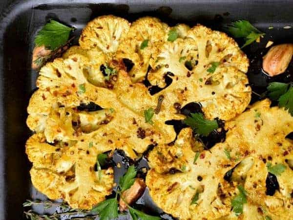 A dish is filled with food, with Roasted cauliflower