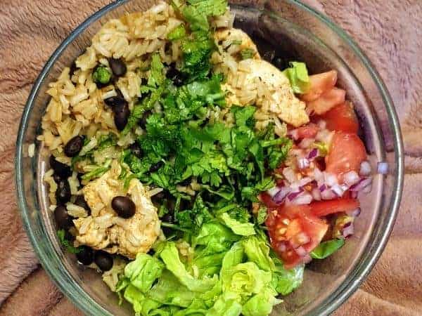Rice chicken and salad bowl as a lunch for those following the plan
