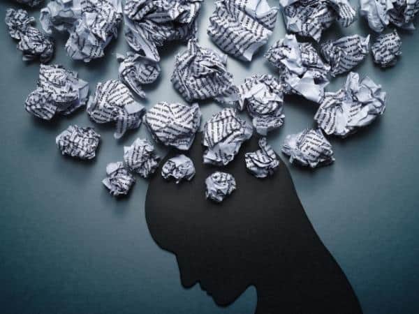 sillhouette of a head showing crumpled paper of different thoughts without the help of the mental health portfolio