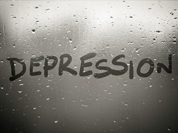 Depression written on a wet window