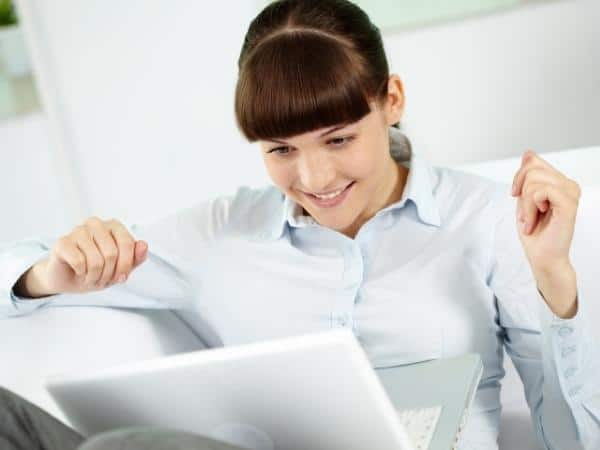 LAdy cheering at herself on a laptop, something to write for your portfolio and help when you are depressed