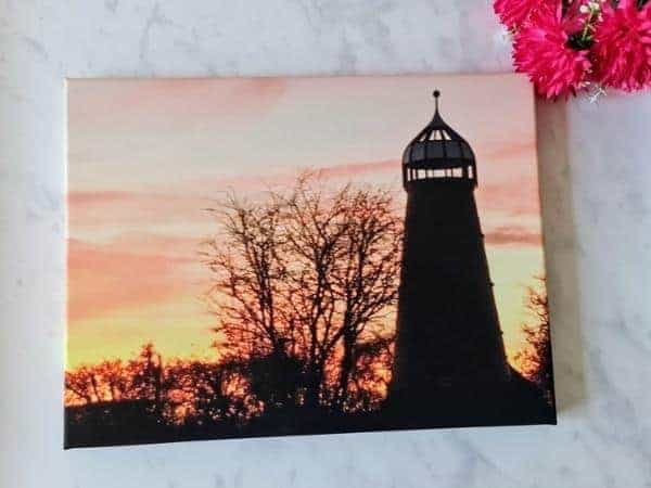 picture of a large tall windmill at sunset