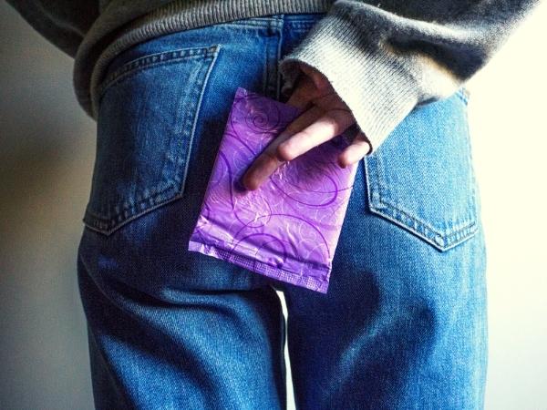 lady holding a sanitary towel behind her body