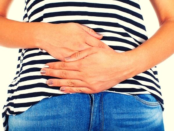 lady holding stomach in pain