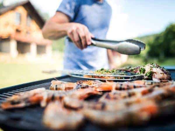 man turning food on a bbq