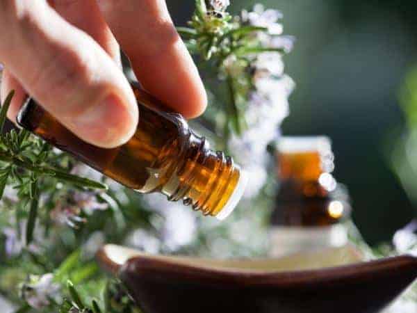 Person dripping essential oil