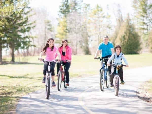 A group of people riding on the back of a bicycle