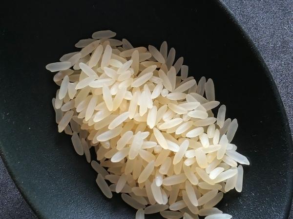 A close up of rice on a black spoon