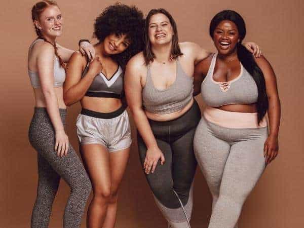 four women all different races and sizes smiling