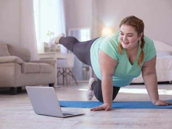 lady exercising with stretching make time for workouts