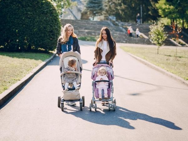 two ladies pushing pushchairs