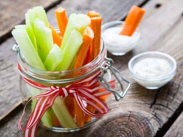 vegetable sticks in a jar on a wooden table