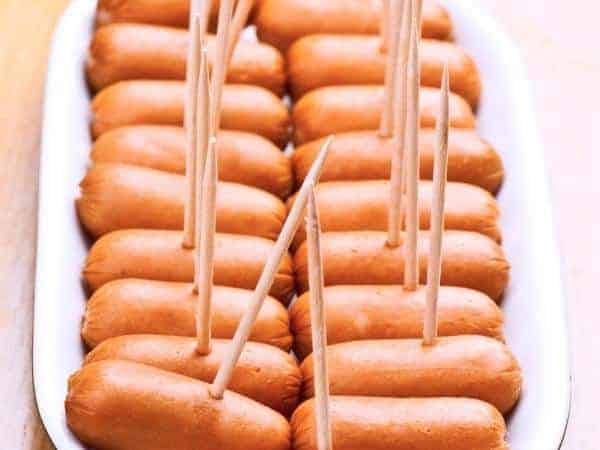A pile of sausages on sticks