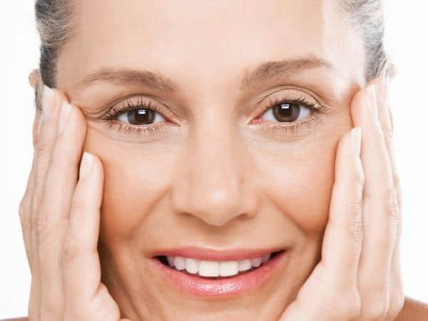 lady smiling holding cheeks