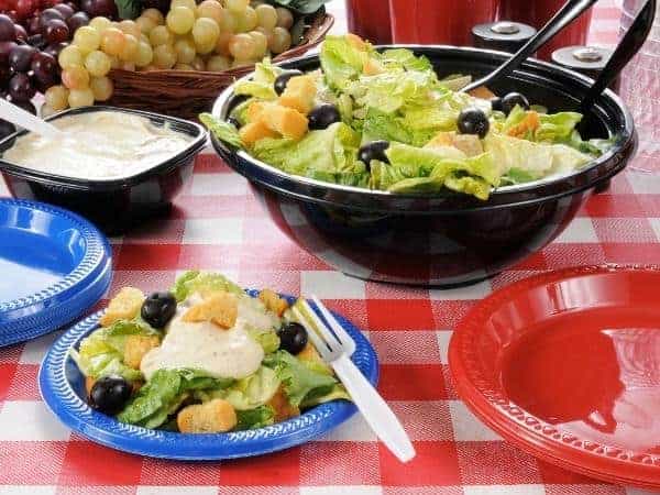 A bowl of food on a table, with Picnic and Salad