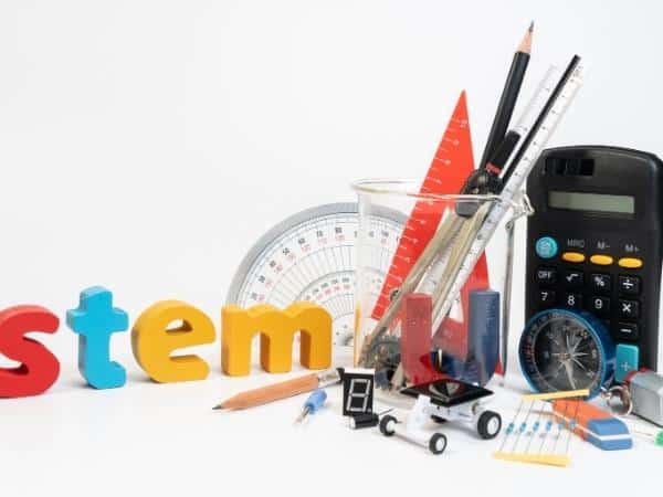 stem written in coloured letters with pencils and maths equipment