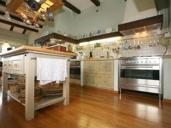 A large kitchen with stainless steel appliances and wooden cabinets