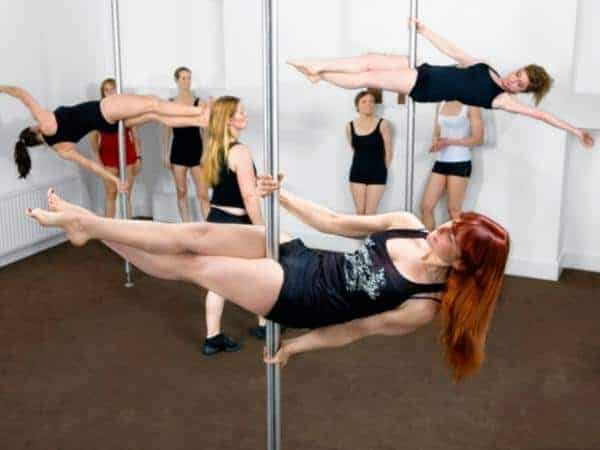 Group of women doing pole fitness