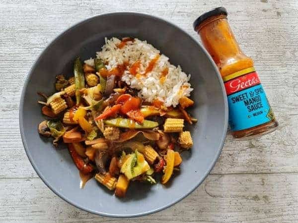 A bowl of stir fry and rice