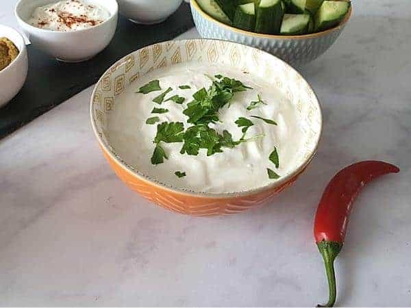 garlic dip in an orange bowl