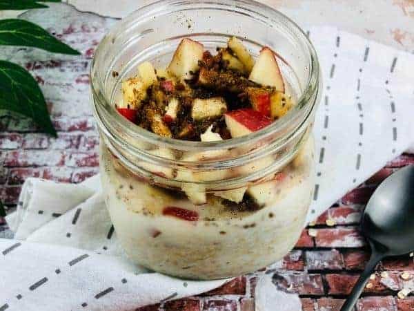 apple and cinnamon overnight oats in a glass jar.