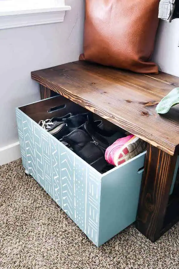 Adding no-fuss shoe storage to a small entryway with a DIY bench and rolling bin is a great way to organize shoes.