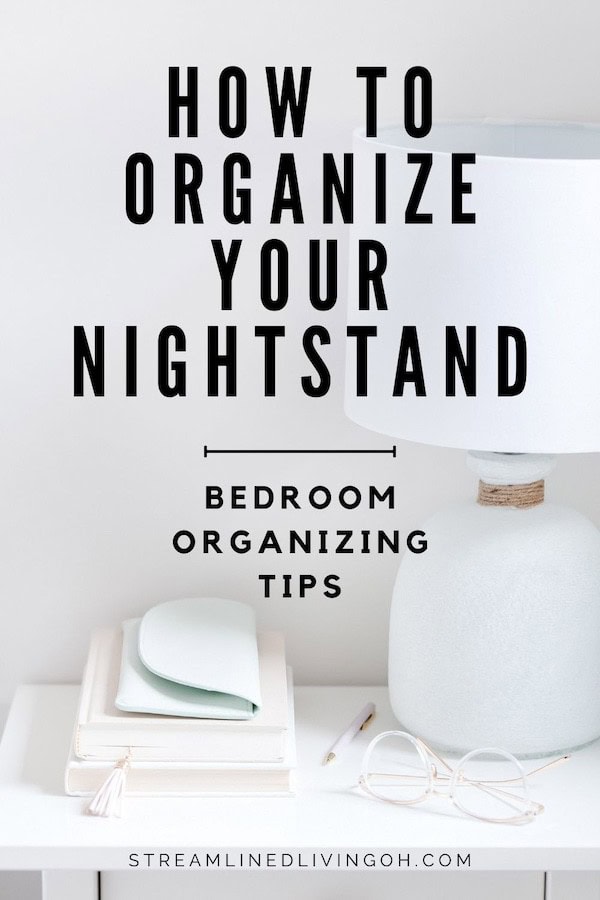 white nightstand with organized objects on surface like table lamps a small stack of books and eyeglasses.