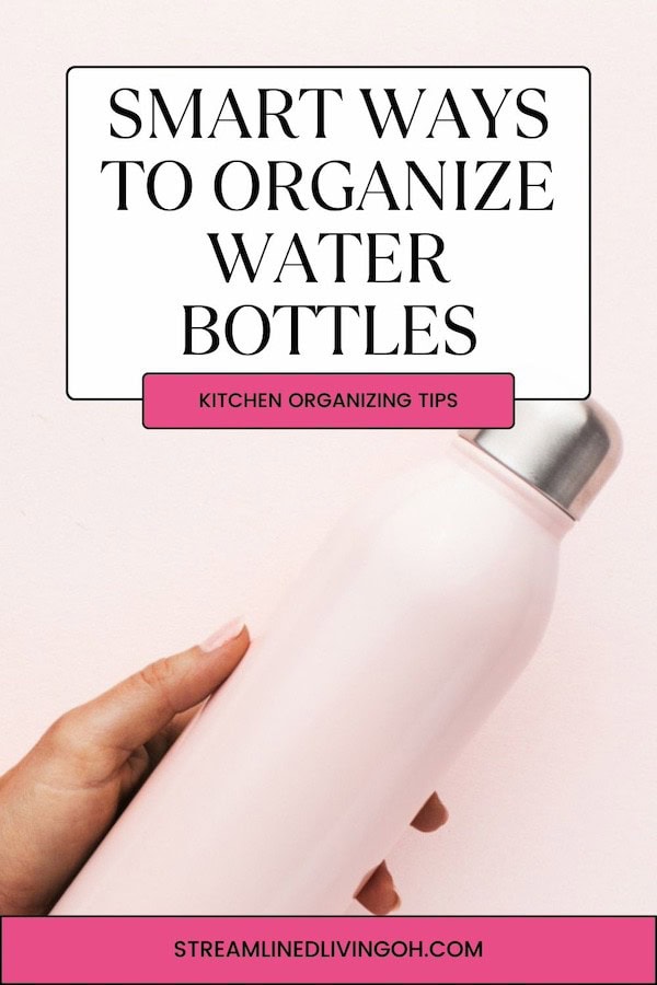 woman holding a pink reusable water bottle against pink background