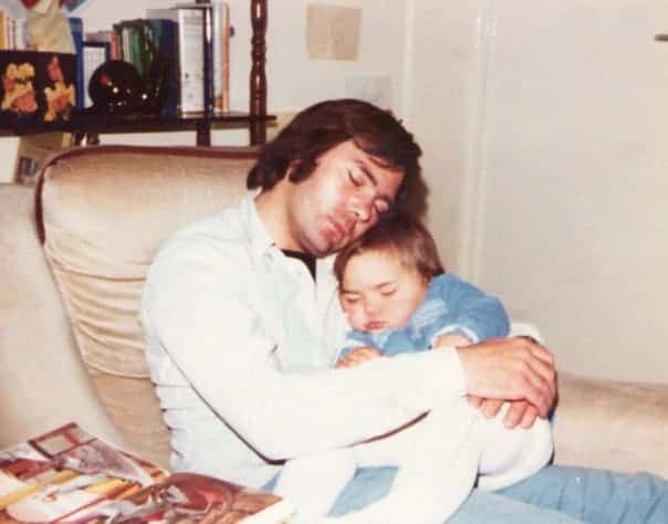 A young girl sleeping on her father
