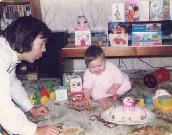 Young girl playing with toys on the floor with her dad