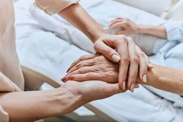 Doctor holding patient hand – Nirvana Clinic Greater Noida – Dr. Manuj Sondhi & Dr. Debolina Chowdhury
